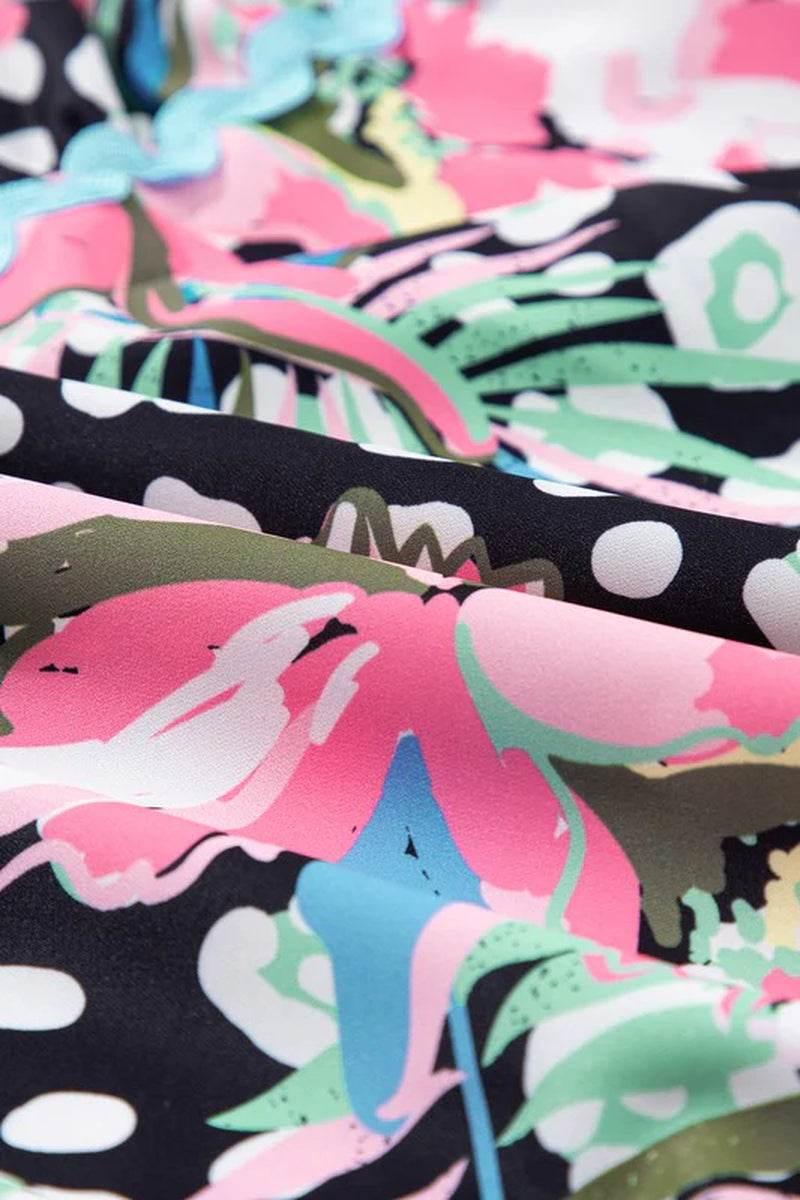 Close-up of floral ricrac embellished fabric in pink, green, and black, showcasing a vibrant print for a mini dress.