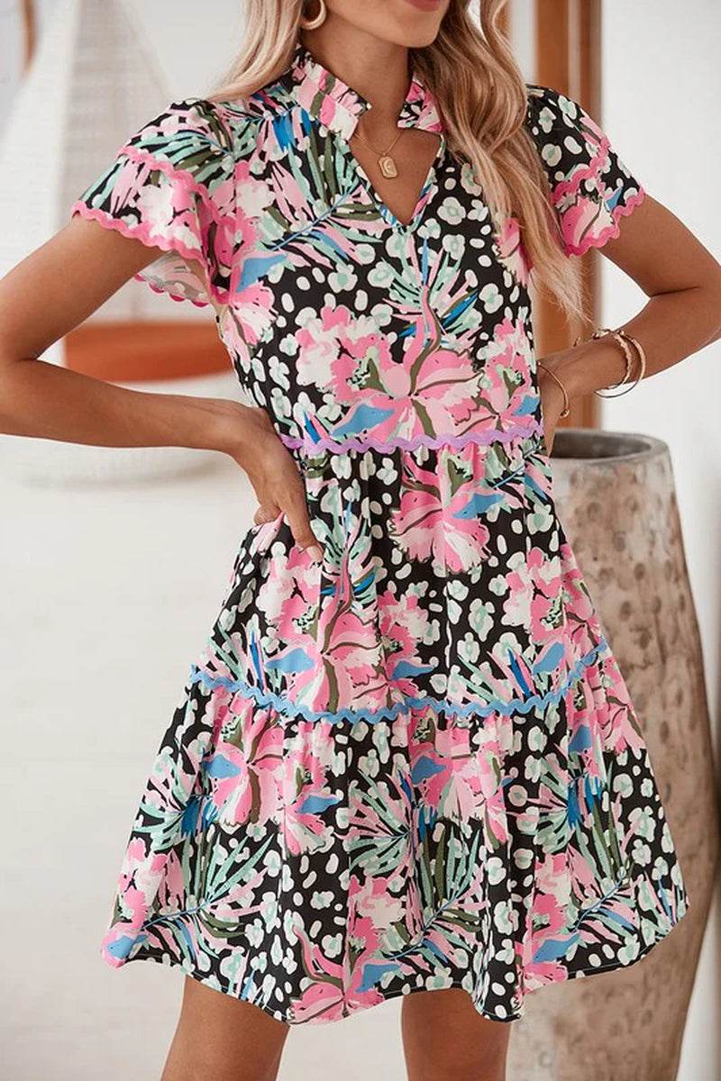 Floral ricrac embellished tiered mini dress with leopard and floral prints, perfect for warm weather and layering.