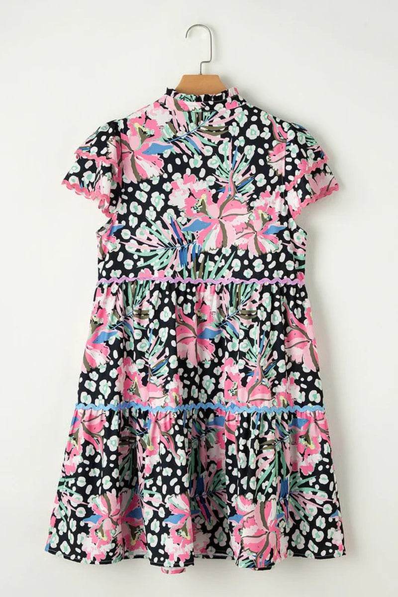 Floral ricrac embellished tiered mini dress with vibrant pink and blue prints, perfect for warm weather styling.