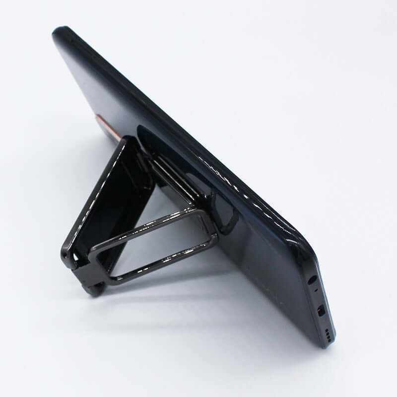 Foldable mobile phone holder supporting a smartphone at an adjustable angle for comfortable viewing.