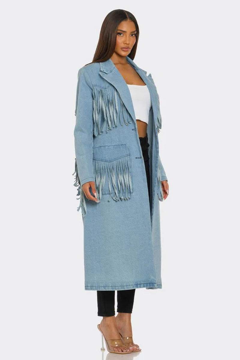Fringed longline denim trench coat in light denim worn over a white crop top and black pants, showcasing edgy style.
