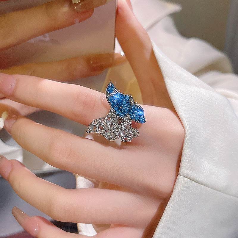 Glamorous ethnic-inspired crystal butterfly ring in silver on woman's finger