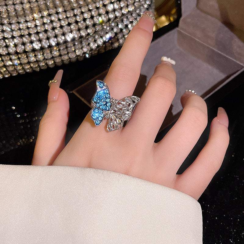 Silver glamorous ethnic-inspired butterfly crystal ring on woman's finger