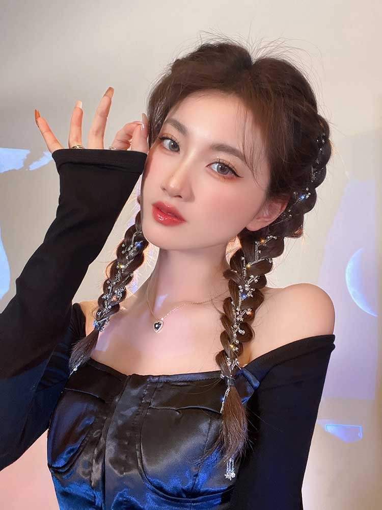 Woman wearing black satin top with hair braid side chain premium hair clip decorated with rhinestone star-shaped white crystals