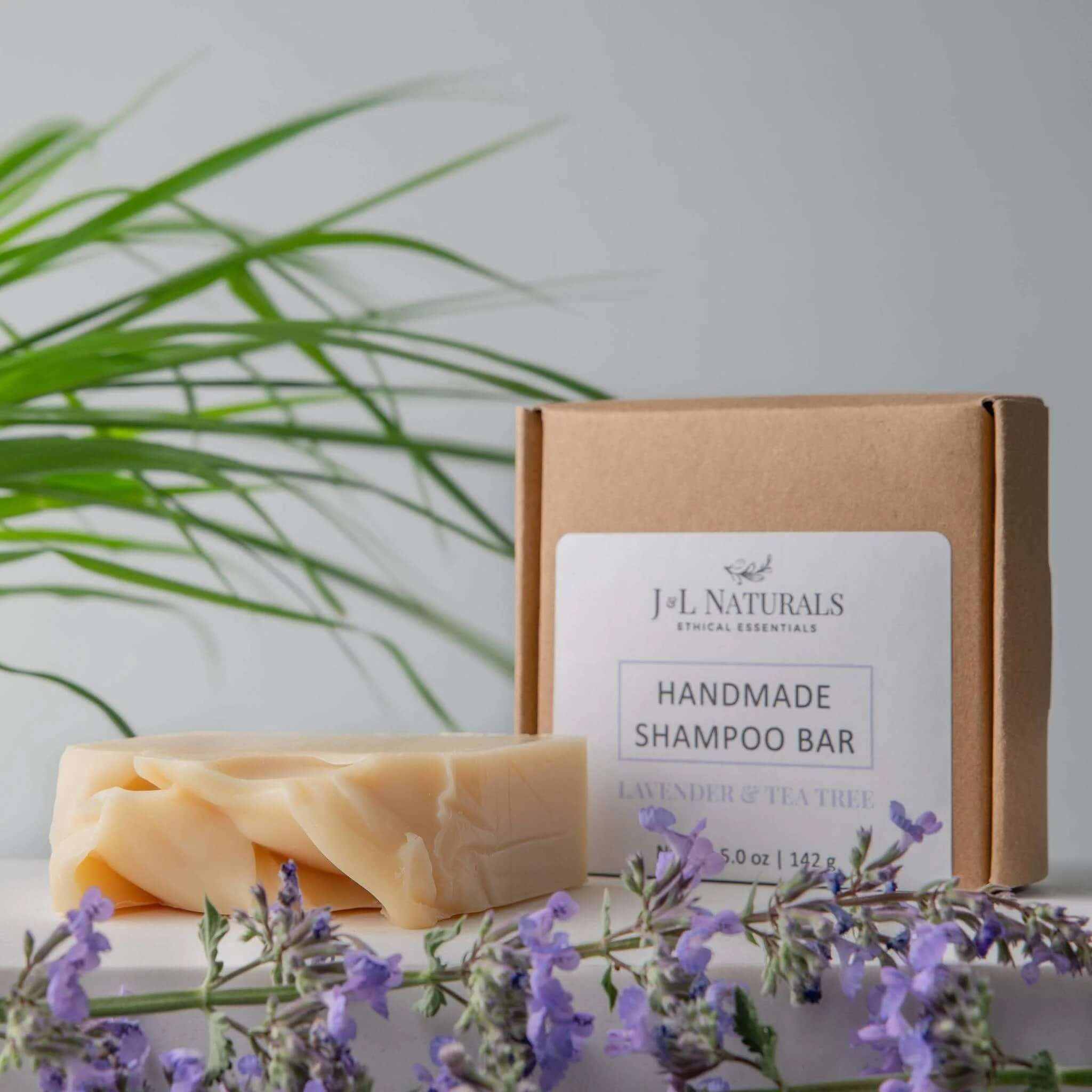 Men’s Natural Beard Shampoo wash bars with lavender and tea tree scent, handmade and packaged in eco-friendly box with fresh lavender flowers nearby