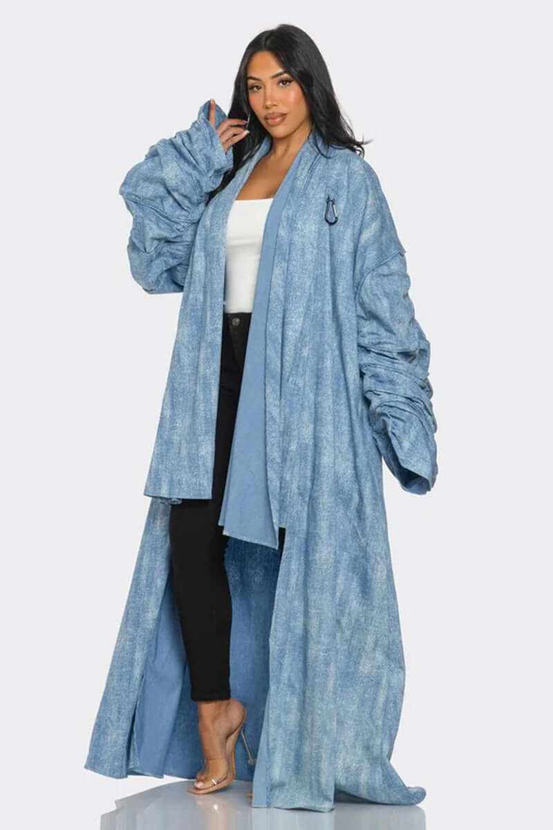 Model wearing a maxi longline denim duster coat with ruched sleeves, showcasing a light wash denim design.