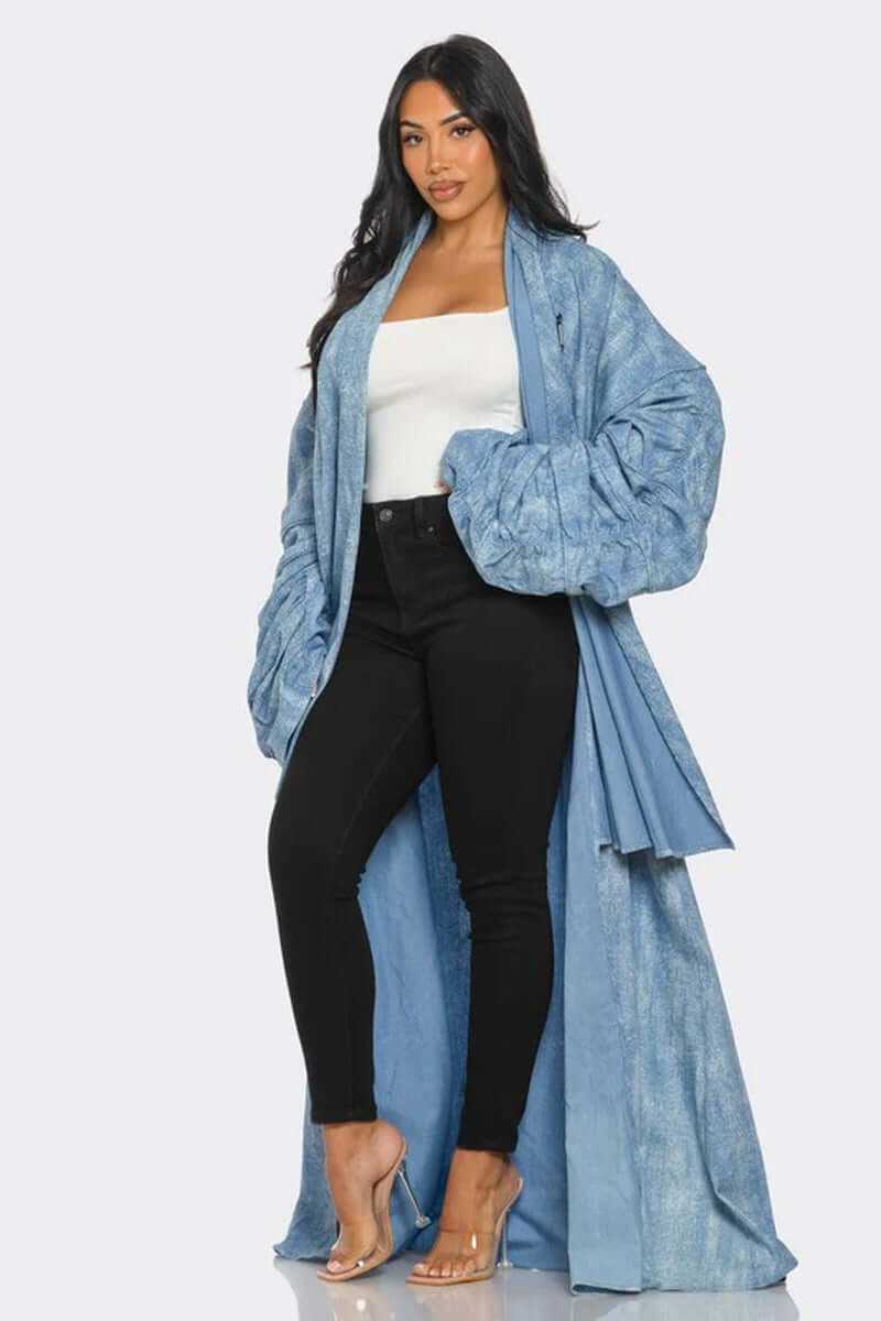 Model showcasing a maxi longline denim duster coat with ruched sleeves over black pants.