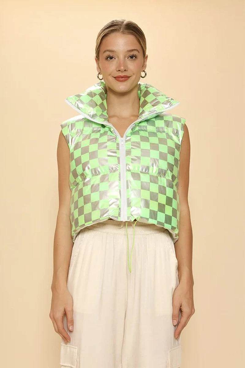 Model wearing a green and silver checkered metallic puffer vest with a mock neck and cropped fit.