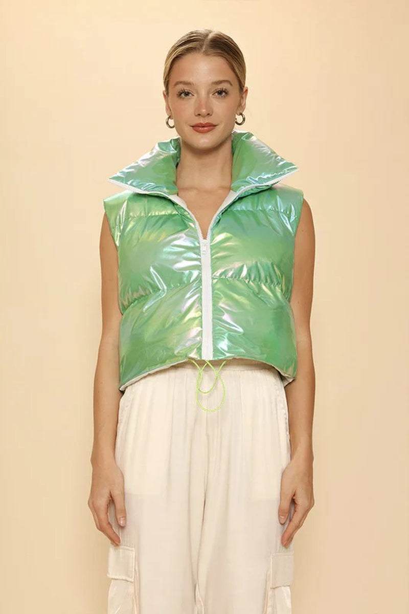Model wearing a metallic green puffer vest with a mock neck and cropped design, showcasing exclusive in-house design.