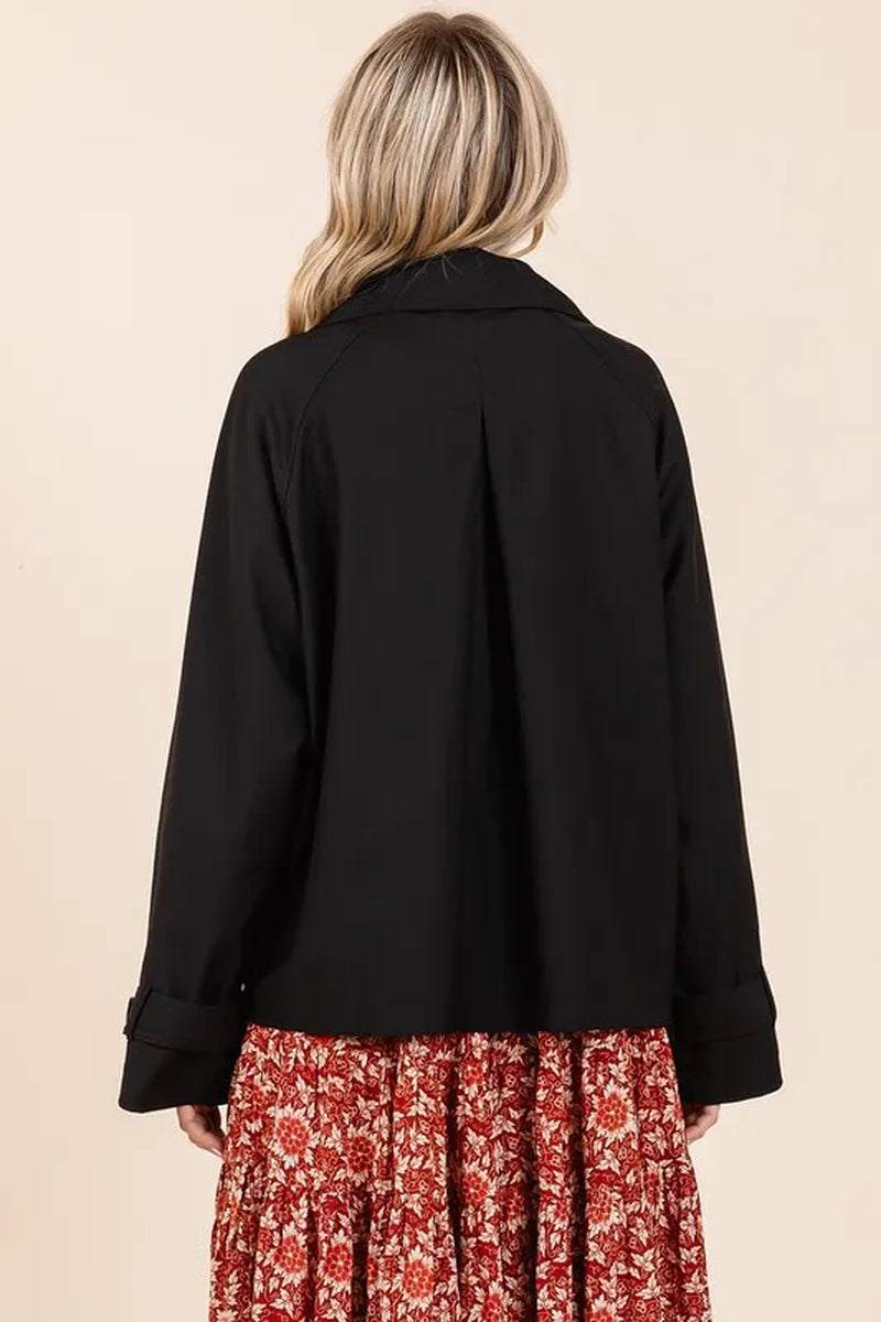 Black double breasted trench coat jacket with long sleeves on woman from back side