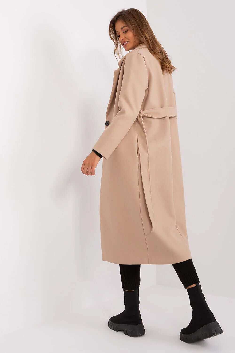 Model wearing the Och Bella belted trench coat, showcasing its long design and stylish back detail.