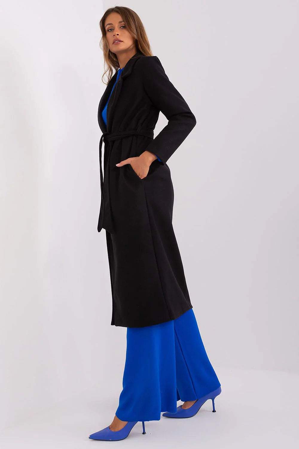 Model wearing the Och Bella Classic Belted Wool Coat in black over a blue outfit, showcasing a stylish and practical design.