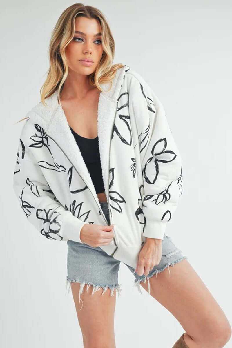 Cozy Oita jacket featuring a floral print, soft sherpa lining, and hooded design, perfect for casual style.