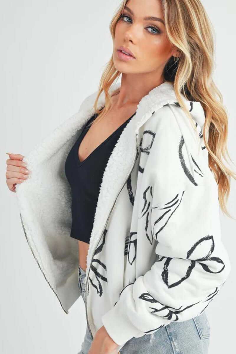 Model showcasing the Oita jacket with sherpa lining and oversized fit, featuring a stylish bomber silhouette.