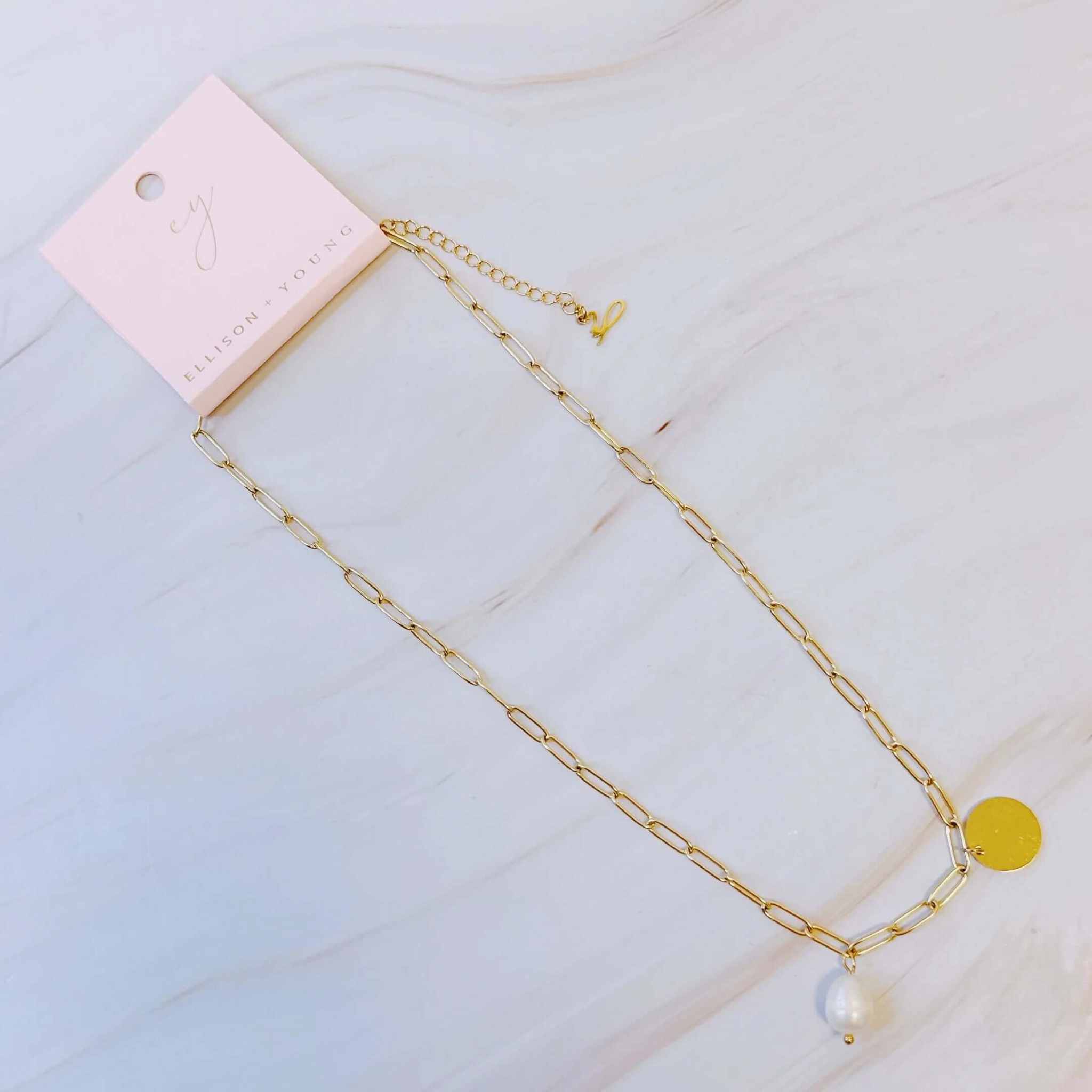 Elegant pearl and gold disc chain necklace with extender tag, perfect for any occasion.
