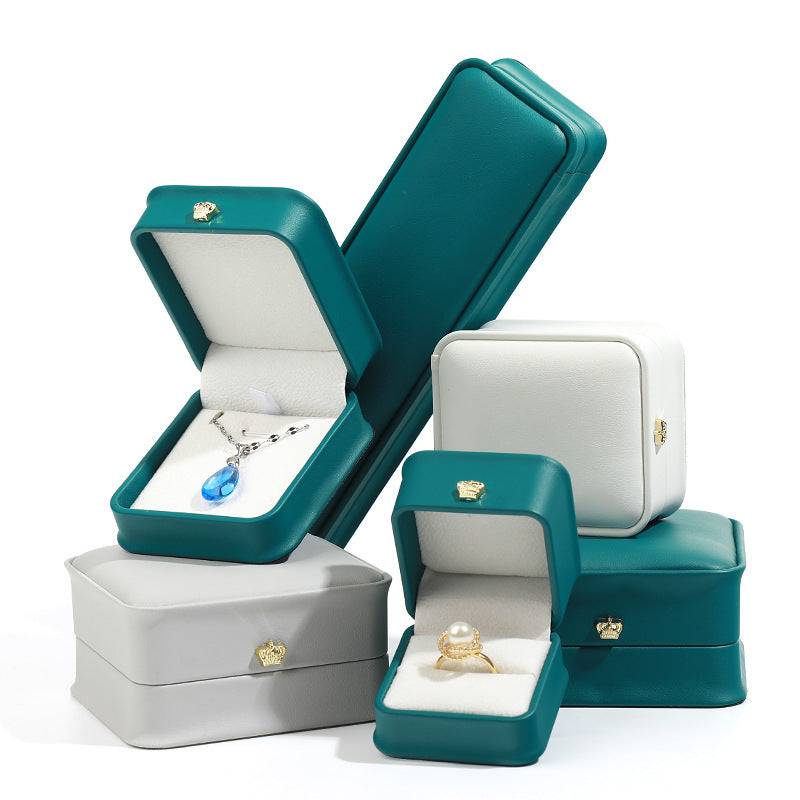 Stylish pendant and lace bracelet display case in teal and gray, perfect for jewelry organization.