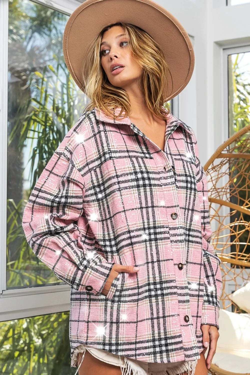 Plaid sequin statement jacket in pink with black accents, worn with a stylish hat, capturing vintage glamour and modern flair.