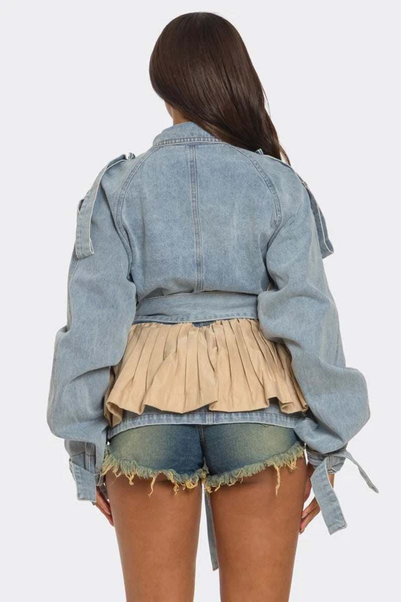 Back view of a pleated contrast denim jacket with a beige panel, styled with denim shorts.