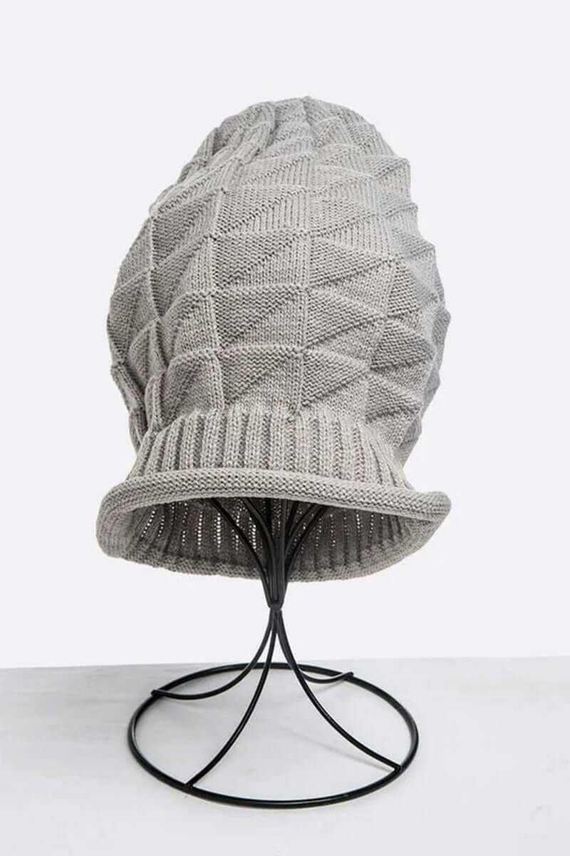 Gray ribbed unisex slouchy knit beanie displayed on a stand, perfect for cold weather style and comfort.