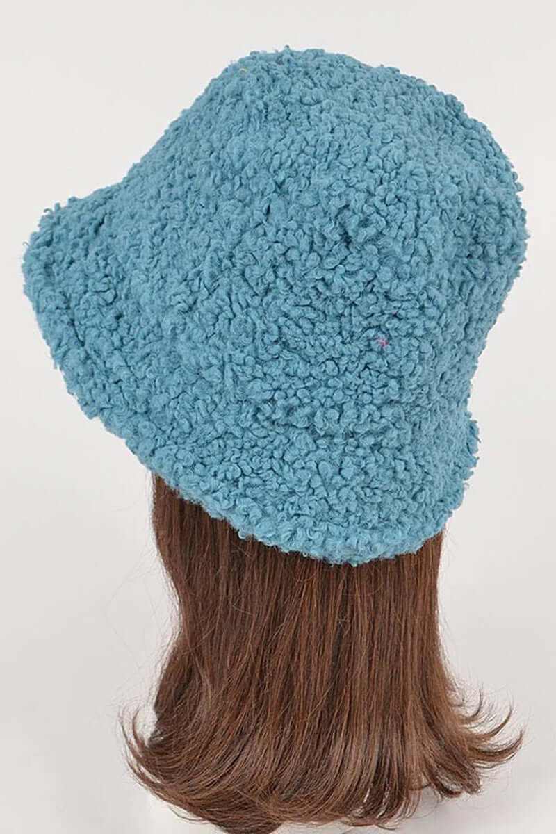 Trendy shearling faux fur bucket hat in blue, perfect for staying warm this winter.
