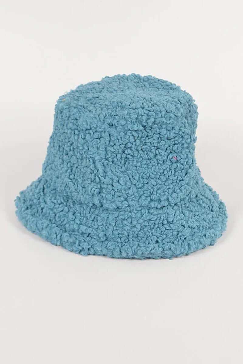 Trendy blue shearling faux fur bucket hat with a cozy texture, perfect for winter outfits.