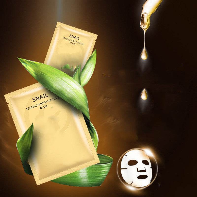 Snail Moisturizing Whitening Mask gold packaging with green leaves and serum drop on dark background