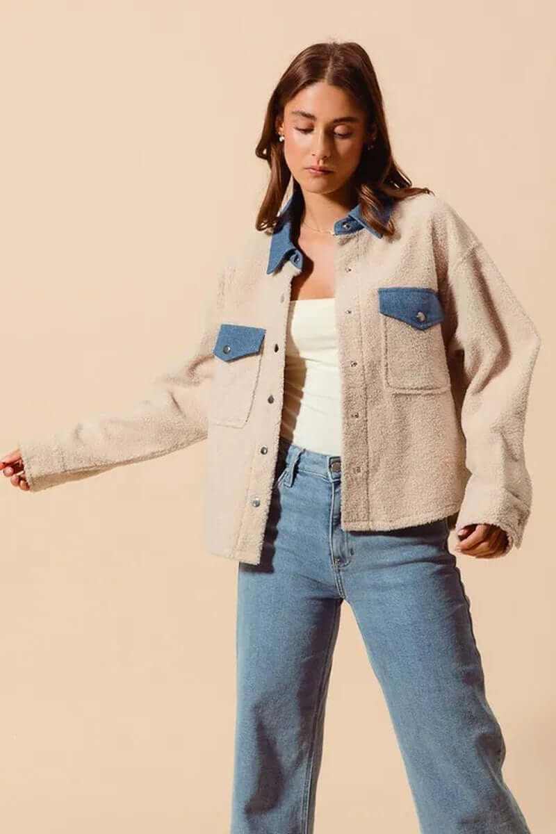 Stylish woman wearing SO ME faux sherpa fur shacket with denim collar, perfect for cozy, chic outfits.