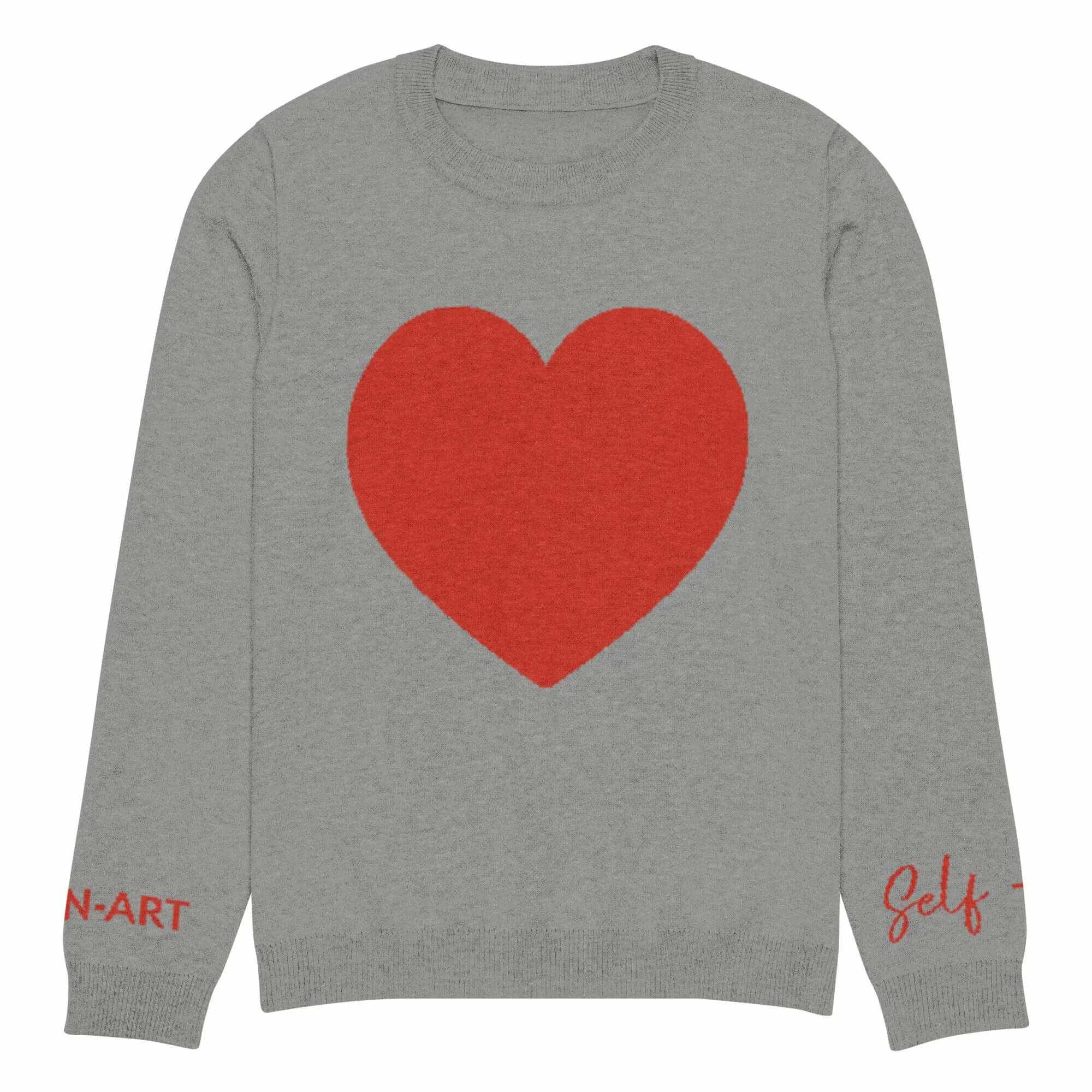 Soft cozy grey crew neck sweater with red heart design and stylish text details on sleeves.