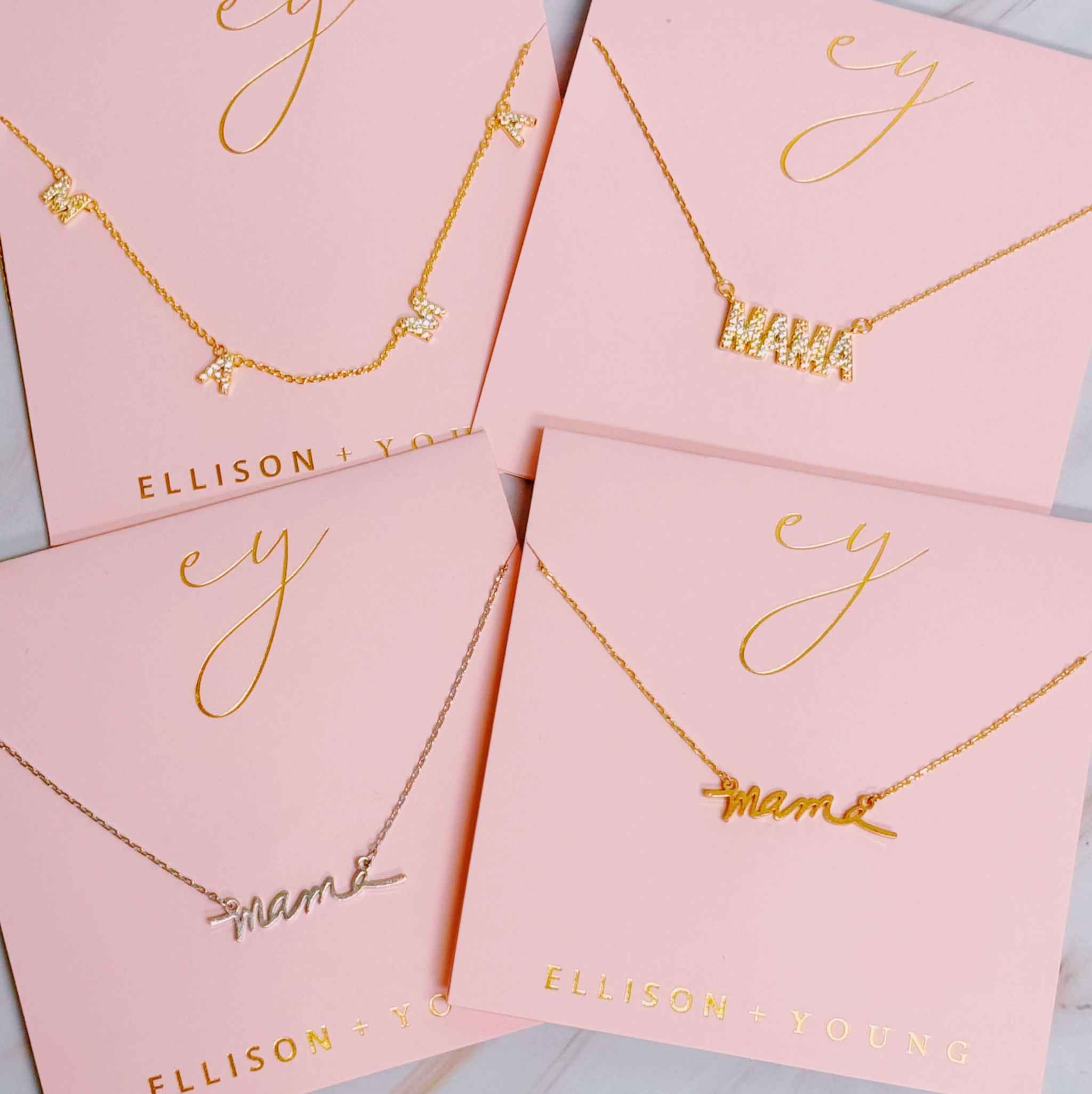 Variety of Sparkle Mama pendant necklaces displayed on pink cards, perfect gifts for Mother's Day or birthdays.