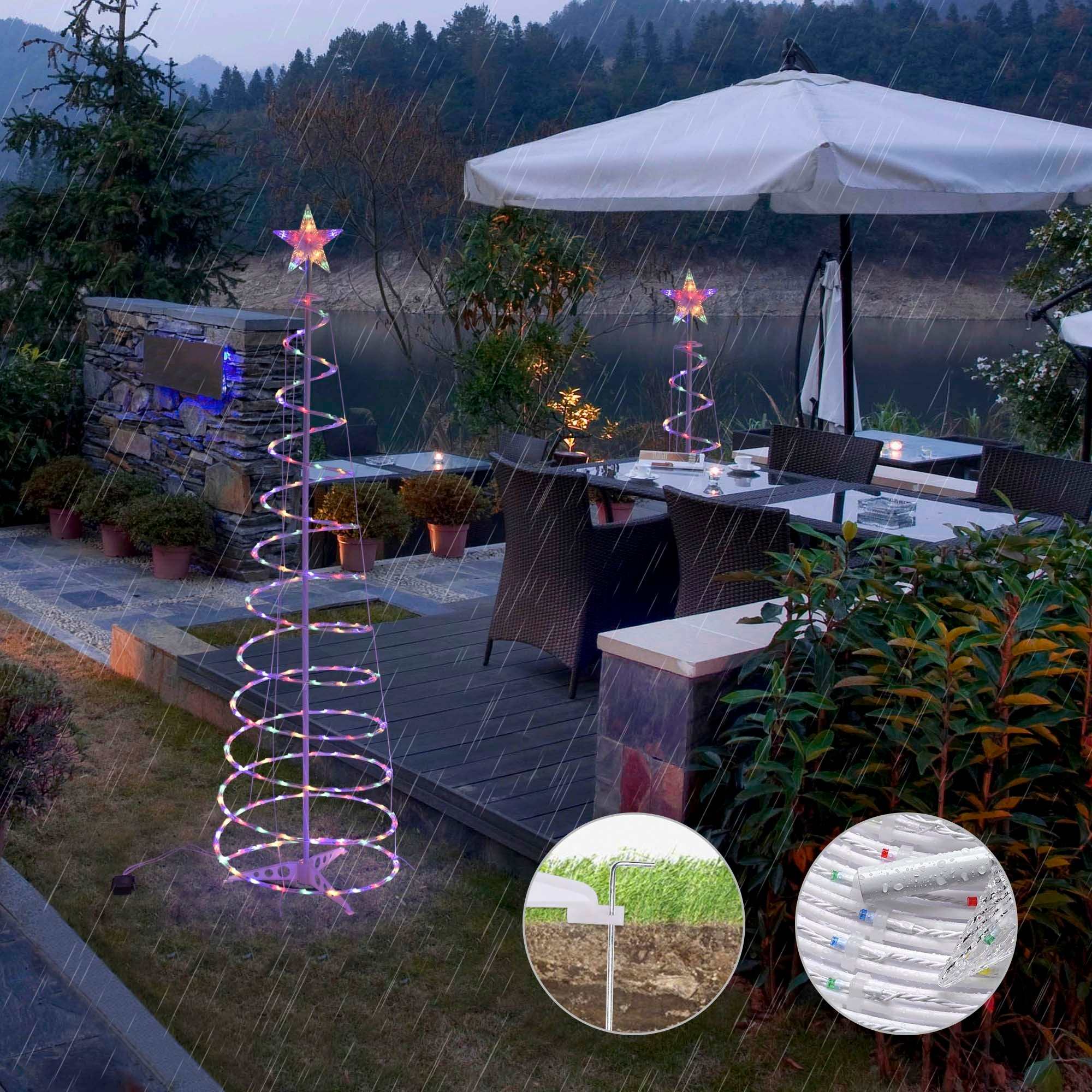 spiral Christmas tree lights illuminating a patio area, featuring a star on top and surrounded by plants, perfect for festive outdoor decor.