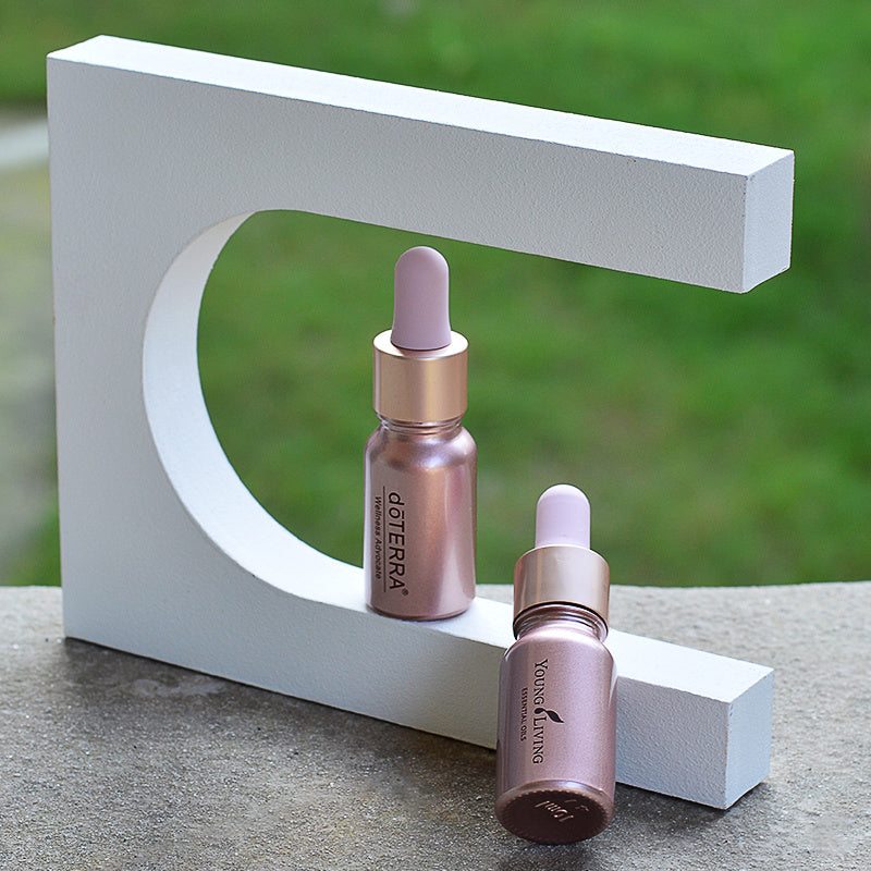 Rose gold dropper bottles for essential oils with matte finish and metallic caps.