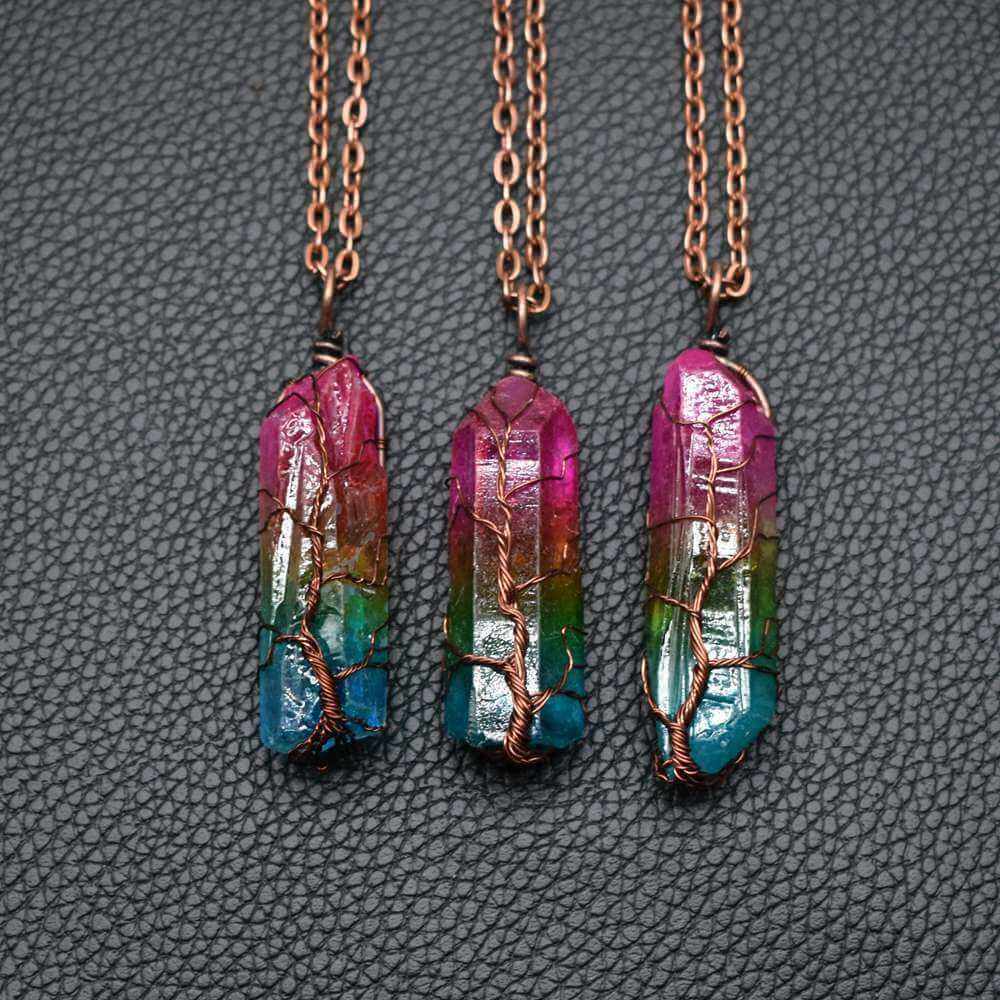 Colorful stone crystal pillar pendant necklaces with copper chains on a black background.