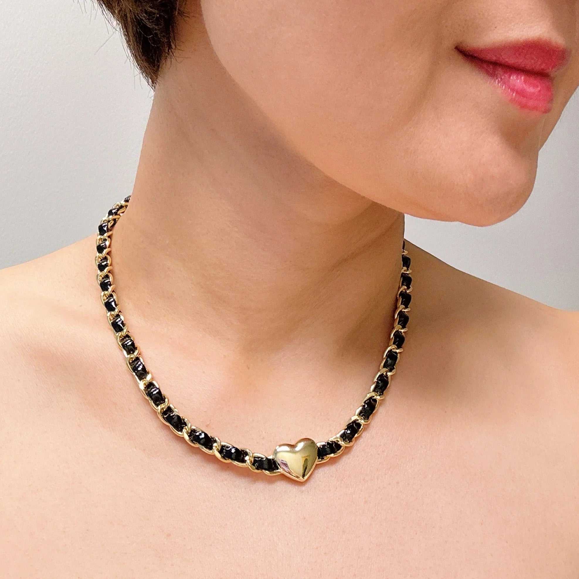 Model wearing a streetwear edgy heart chain choker necklace with gold accents and a sleek design.