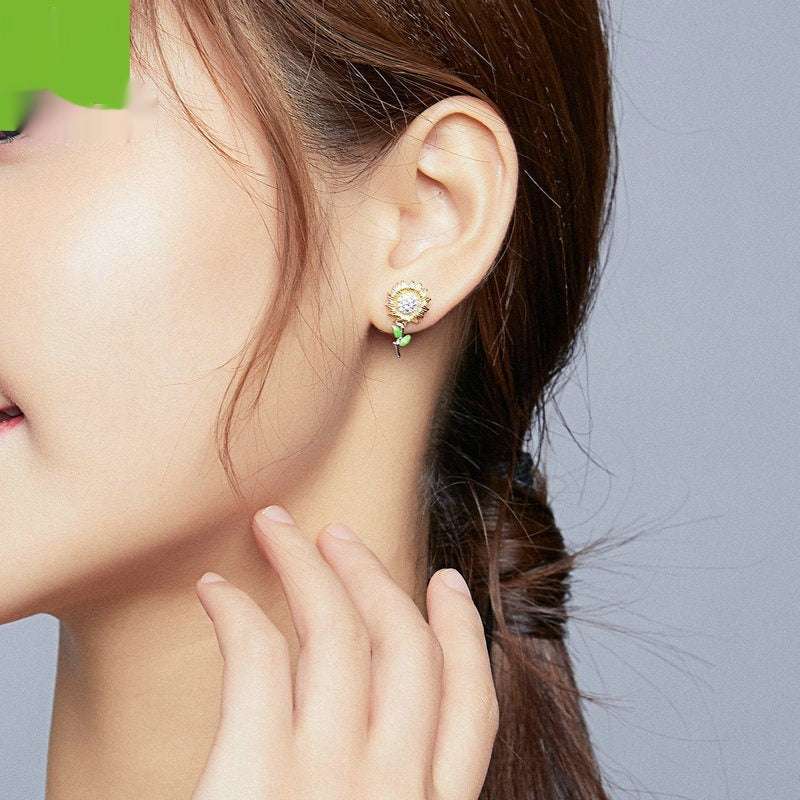 Sunflower S925 silver stud earrings plated with real gold worn on ear, flower shape design