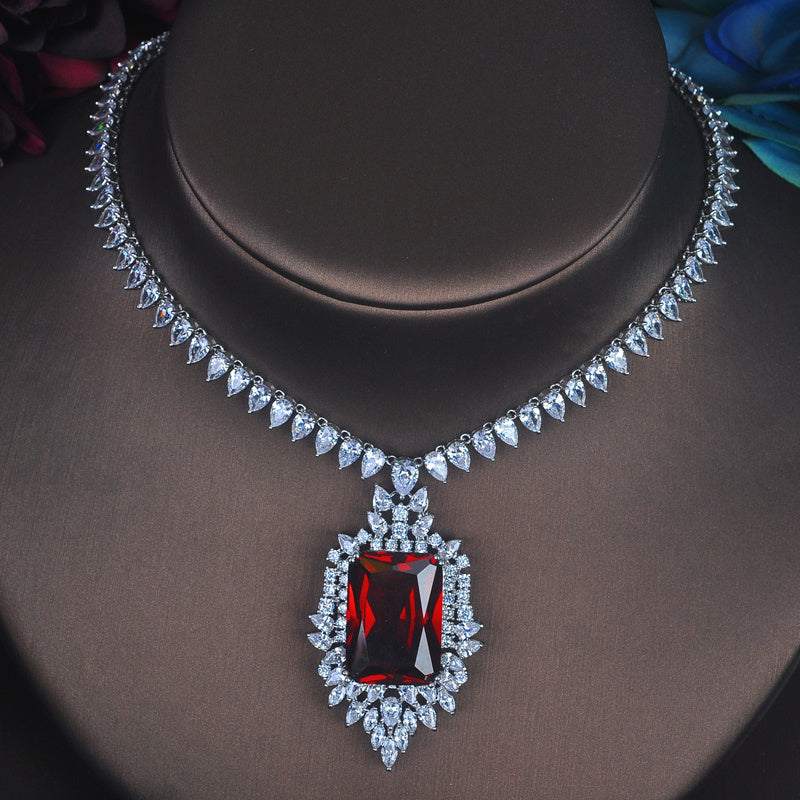 Toast-inspired jewelry set with gold-plated gem inlay featuring a red rectangular pendant and matching earrings
