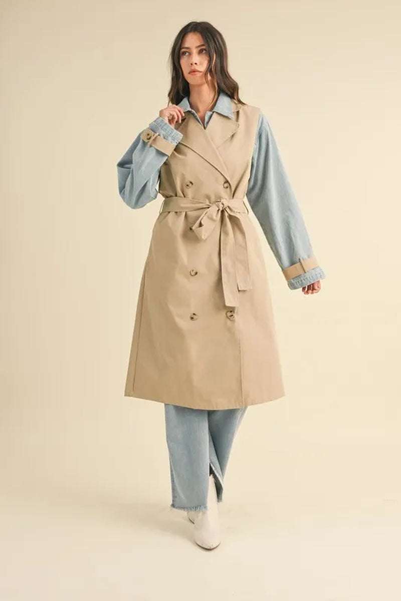 Model wearing a two-in-one MABLE layered trench coat with denim jacket, showcasing a stylish and versatile outerwear combination.