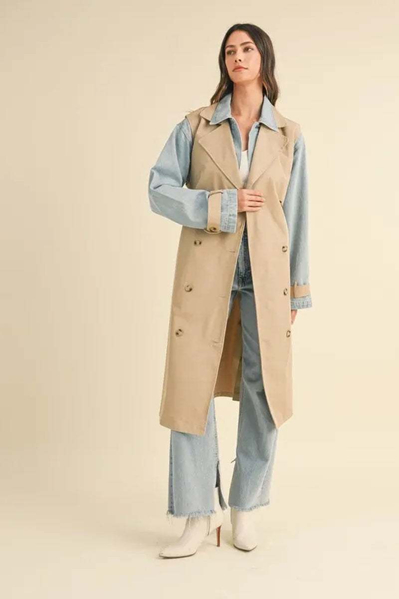 Stylish woman in a two-in-one MABLE layered trench coat with denim jacket for a trendy, transitional weather outfit.