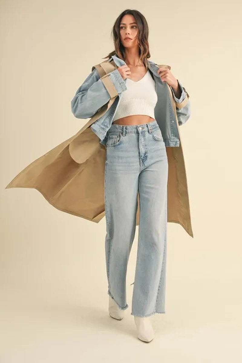Model wearing a two-in-one MABLE layered trench coat with denim jacket, styled with wide-leg jeans and a fitted top.
