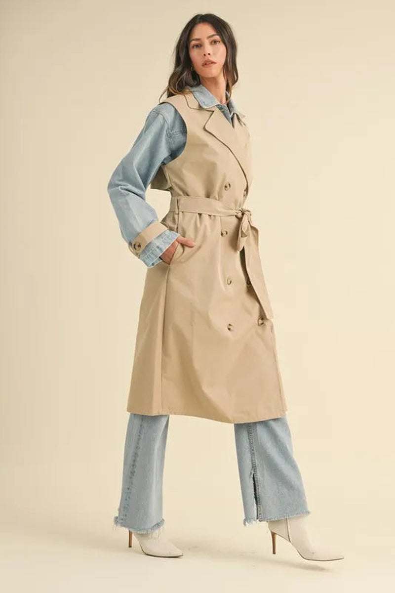 Model wearing a two-in-one layered trench coat with denim, styled for a trendy transitional look.