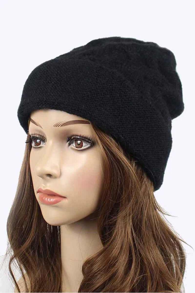 Model wearing a black unisex slouchy fit soft knit beanie for stylish winter warmth.