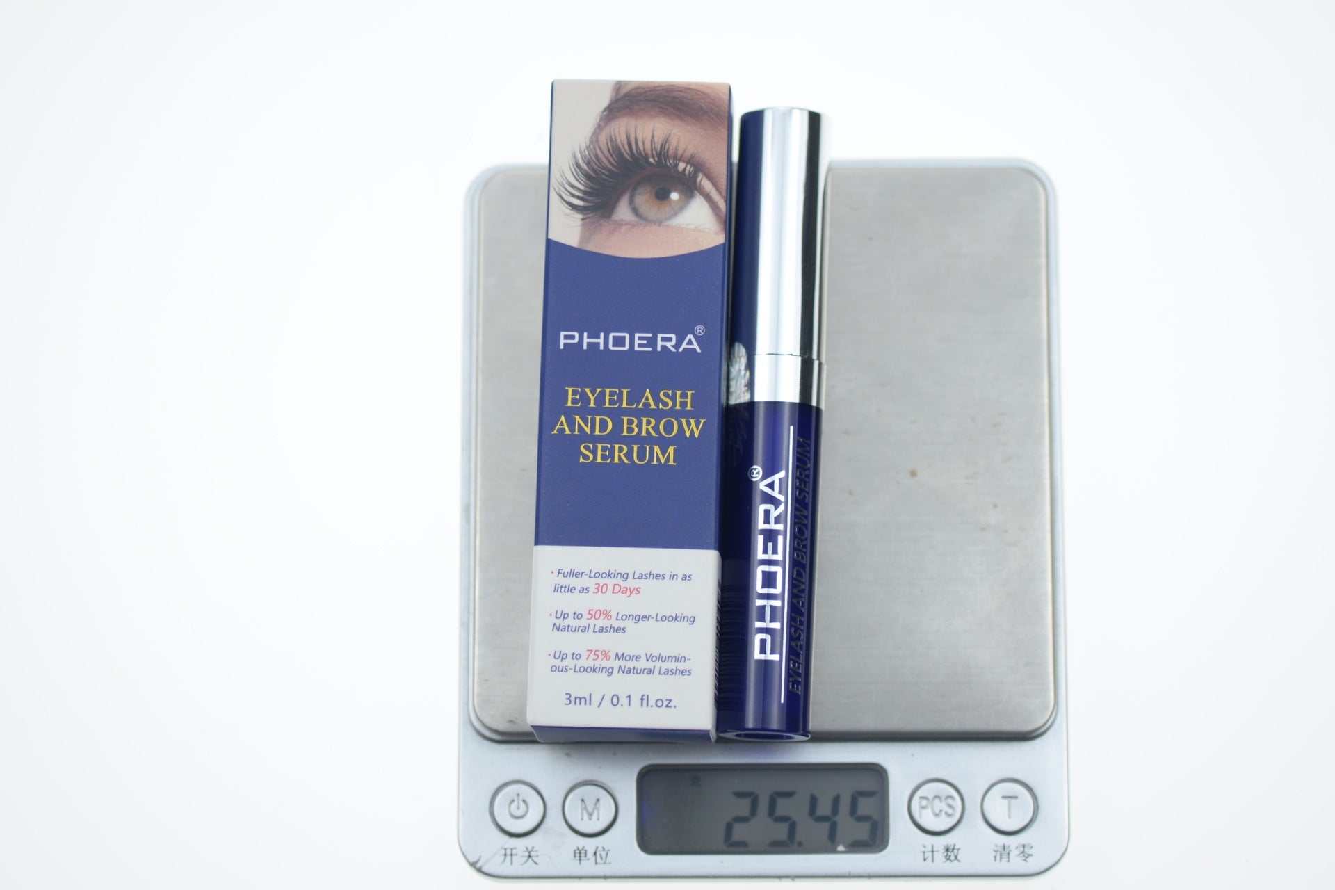 Volumizing Home Mascara eyelash and brow serum in blue packaging on digital scale showing 25.45 grams