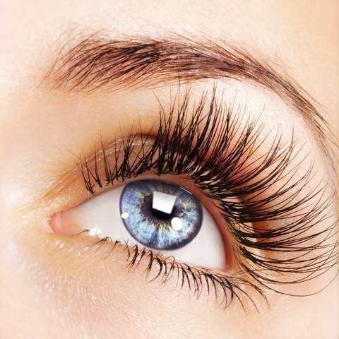 Close-up of blue eye with long voluminous eyelashes using Volumizing Home Mascara for women