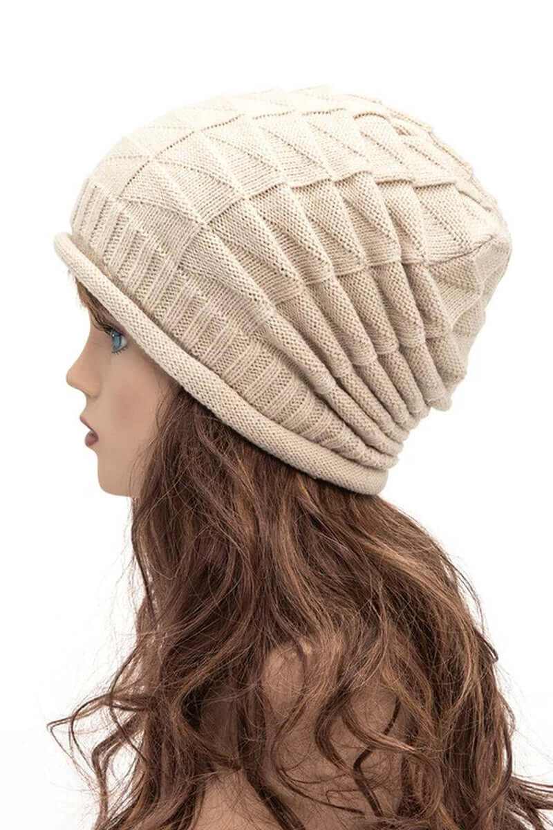 Side view of a warm ribbed unisex raised knit slouchy beanie on a mannequin with long hair.