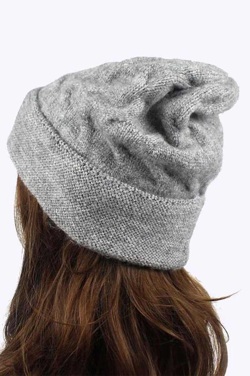 Warm slouchy wool blend cuffed beanie in gray worn from the back, showcasing a cozy knit texture.