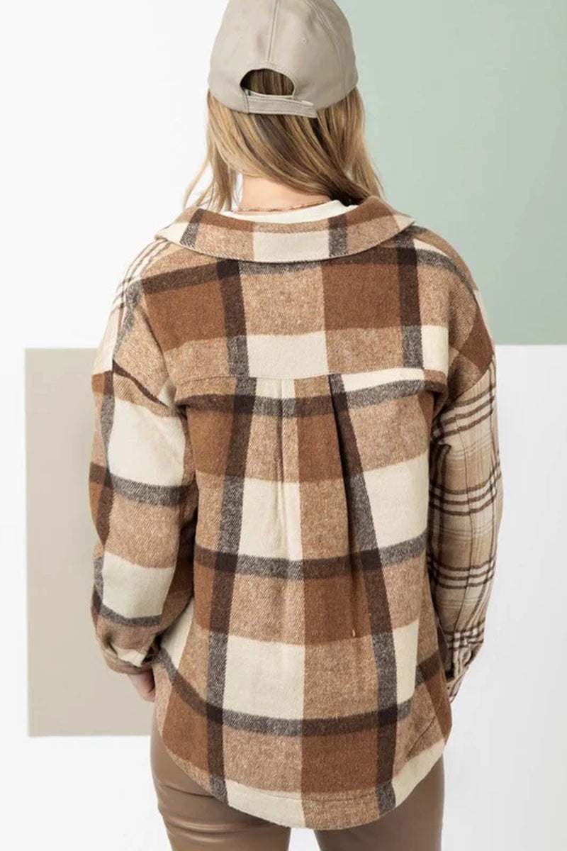 Back view of women's flannel plaid shacket with double flap pockets and relaxed fit in earthy tones.