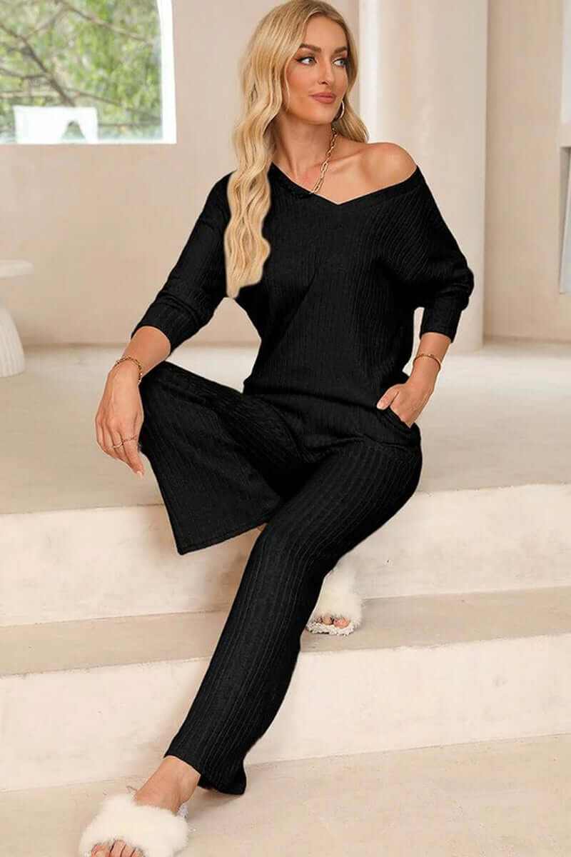 Women in a black ribbed knit V-neck slouchy two-piece outfit, showcasing a relaxed fit and chic style.