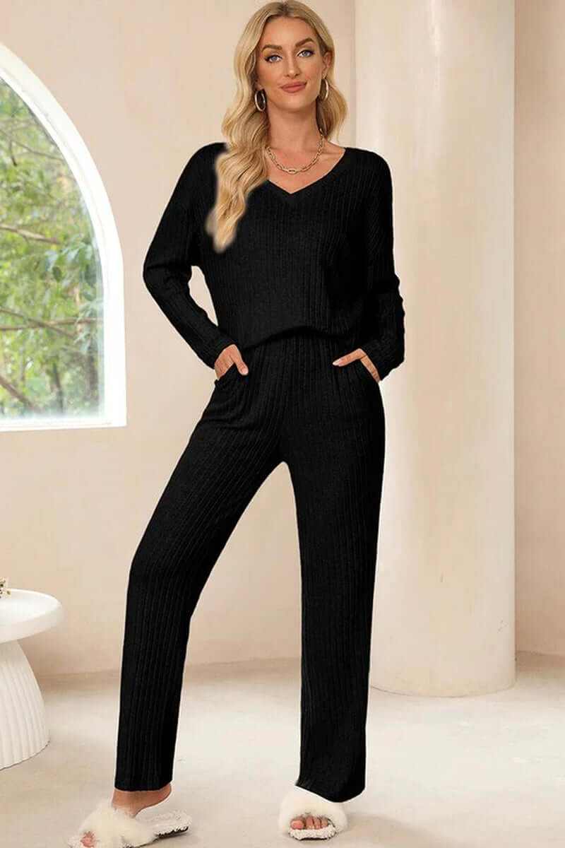 Women in a black ribbed knit V-neck slouchy two-piece outfit with pockets, showcasing comfort and style.