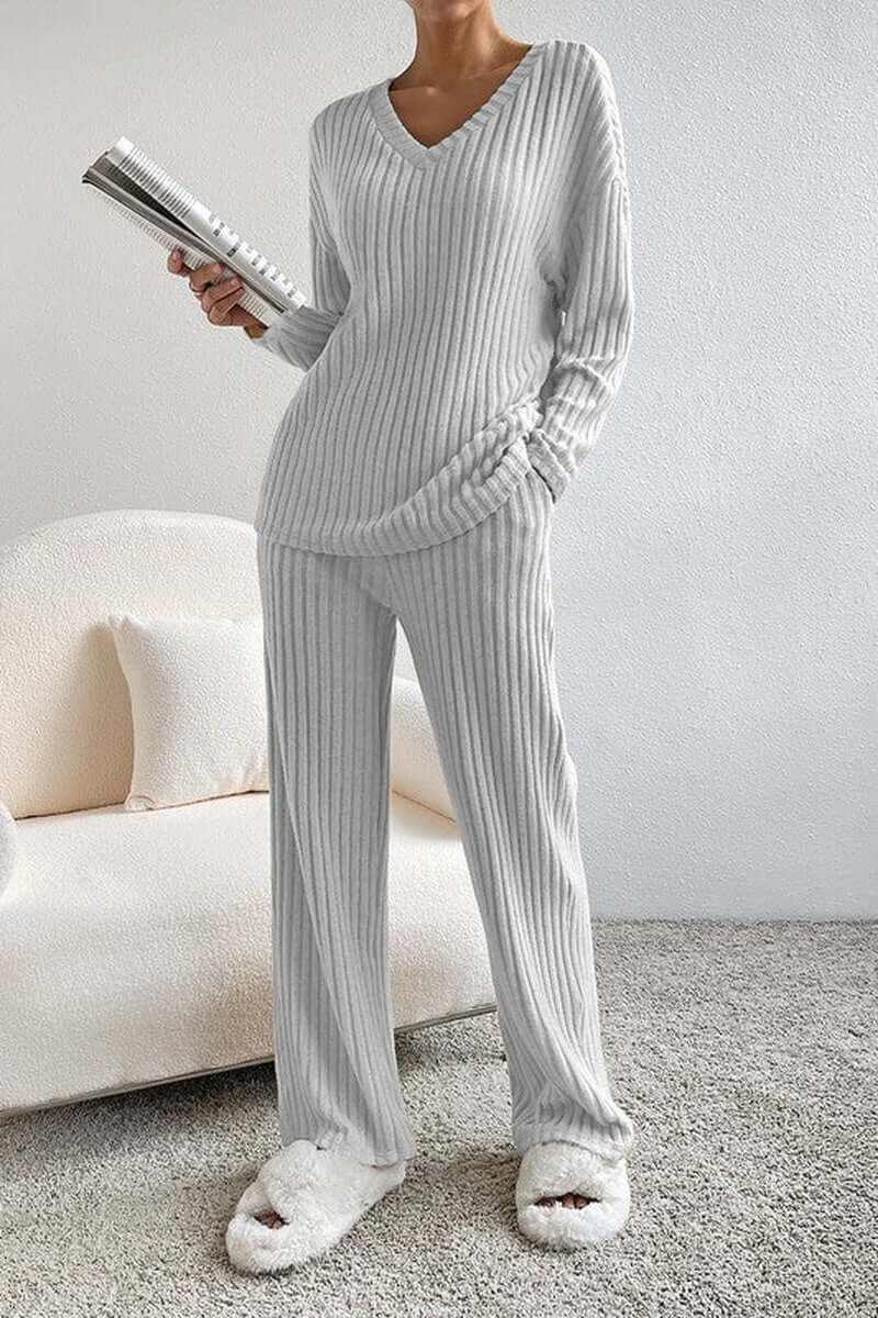 Women wearing a cozy ribbed knit V-neck slouchy two-piece outfit in light gray, paired with fluffy slippers.