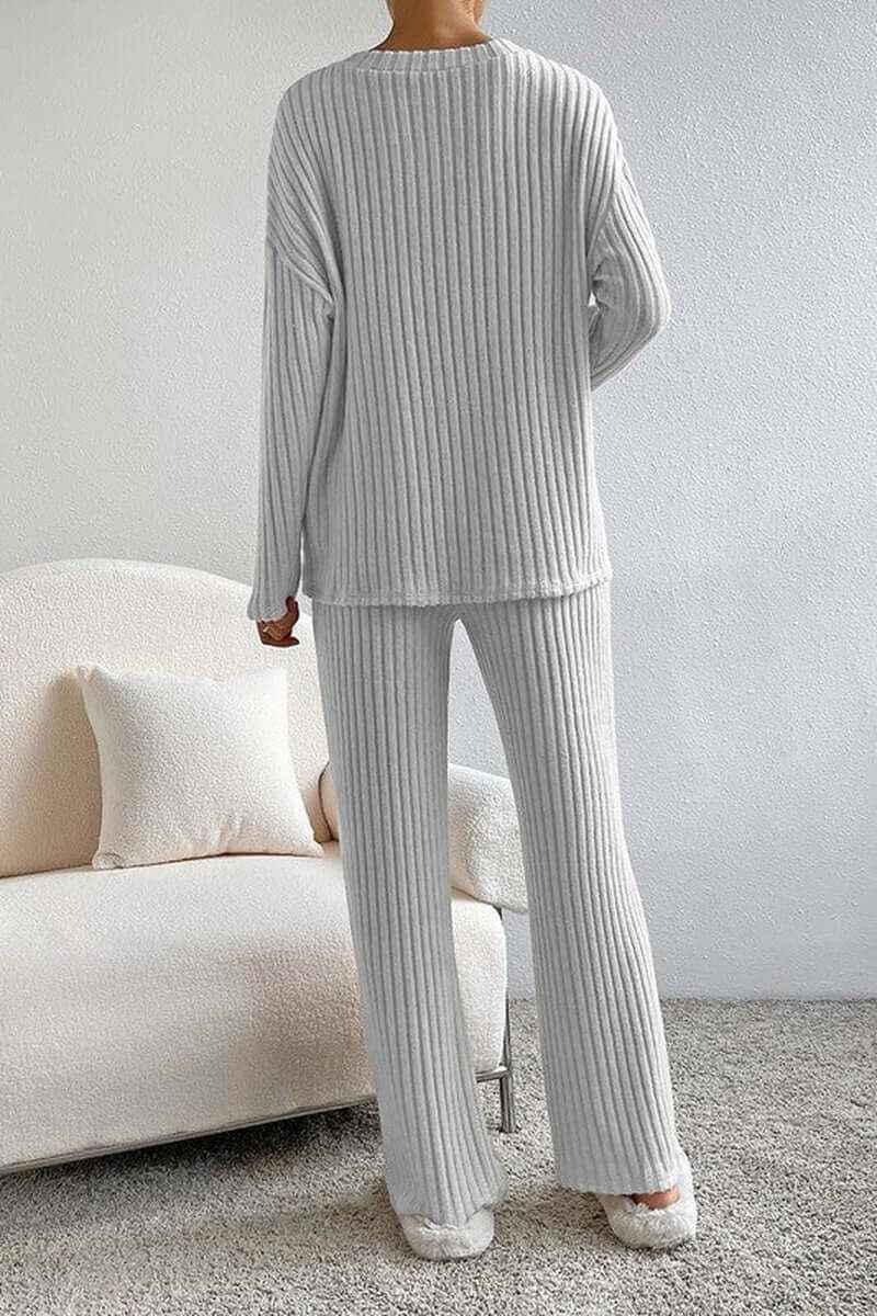 Women ribbed knit V-neck slouchy two-piece outfit in white, showcasing cozy texture and relaxed fit.