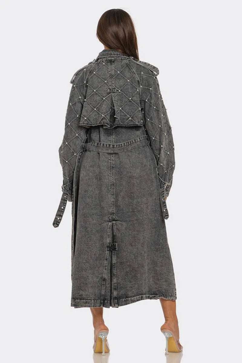 Back view of women's edgy longline denim trench coat with quilted sleeves and studded details.